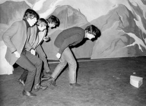 The Beatles stalking a cheese during the rehearsals for Another Beatles Christmas Show, 1964.