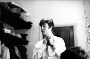 John Lennon from The Beatles posed backstage at the Finsbury Park Astoria, London during the band's Christmas Show residency in December 1963.