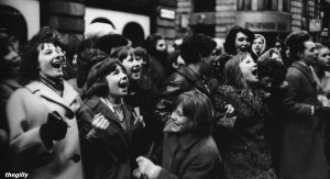 Two more shots of fans waiting outside the London Palladium for the Beatles to arrive, 12 January 1964.