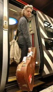 Bob Geldof, with guitar in hand, boards a special train to Edinburgh from Euston station, London, to take his Justice for Africa Campaign to the Scottish capital for the G8 summit, Tuesday, July 5, 2005