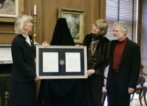 The Rolling Stones' keyboardist, Chuck Leavell, right, with his wife Rose Lane White Leavell, second right, is presented with the Interior Department's top award for 'cooperative conservation' and environmental stewardship, for his work as a tree farmer in Georgia, by Department of Interior Secretary Gale Norton, left, during a ceremony, Tuesday, Oct 4, 2005, in Washington.