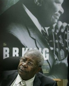 Legendary blues entertainer B.B. King listen as he appeared to autograph his combined new book and CD collection 'The B.B. King Treasures,' before a posters-sized replica of the cover, in New York, Tuesday, Nov. 29, 2005.