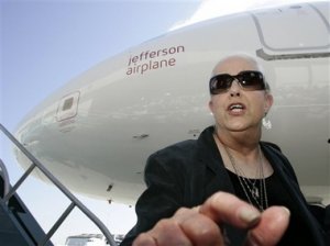 Grace Slick, of the band, Jefferson Airplane, points at the media as she helps dedicate Virgin America's newest headquarters and new plane, 'Jefferson Airplane' at San Francisco International Airport in San Francisco, Wednesday, Oct. 11, 2006.