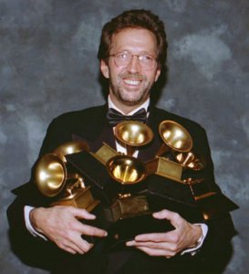 Eric Clapton poses with the six Grammys he won at the 35th annual Grammy Awards in Los Angeles on Feb. 24, 1993. His song Tears in Heaven won both as record and song of the year, and his album Unplugged won as album of the year.